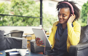 Image of girl using iPad and headphones